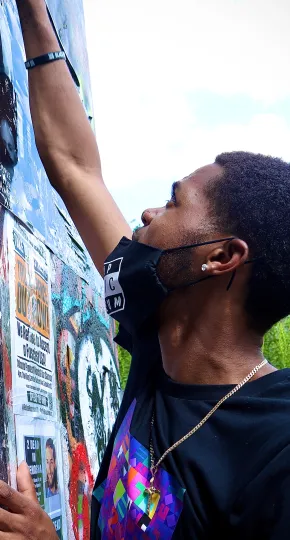 Man working on a mural.