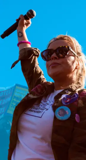 Young activist holding a microphone up.