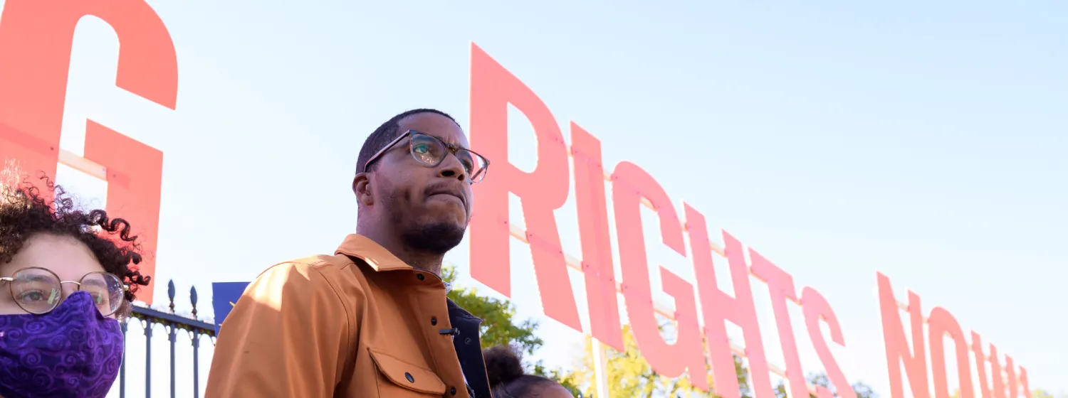 Black man staring into the distance at a voting rights protest