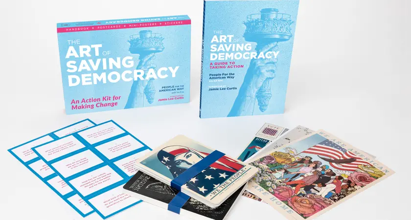 A collection of items from the Art of Saving Democracy, including book, stickers and posters
