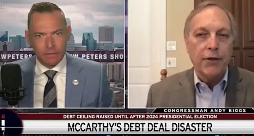 Image is taken from video of the Stew Peters show. It is a split-screen image with host Stew Peters on the left and Rep. Andy Biggs on the right. Text below them reads "McCarthy's Debt Deal Disaster."