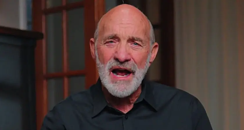 Lou Engle, a bald white man with a gray beard, is seated in what appears to be a home library, speaking directly into the camera.