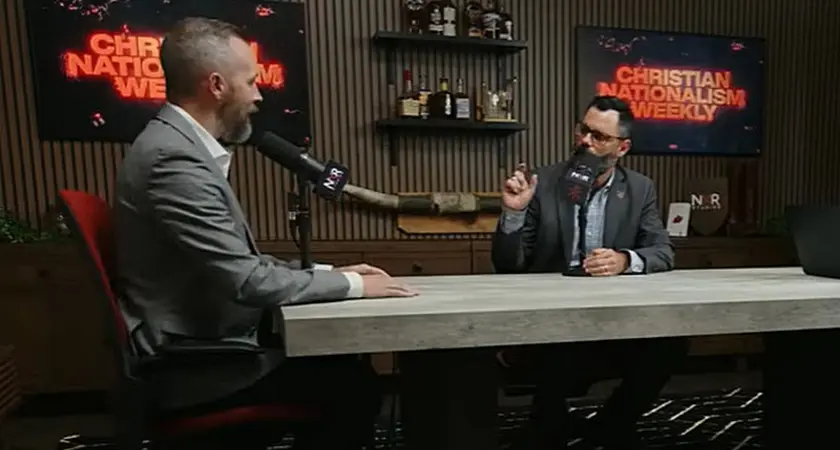 Dale Partridge and Joel Webbon are seated at a table, both with microphones in front of them; screens in the background display the text "Christian Nationalism Weekly"
