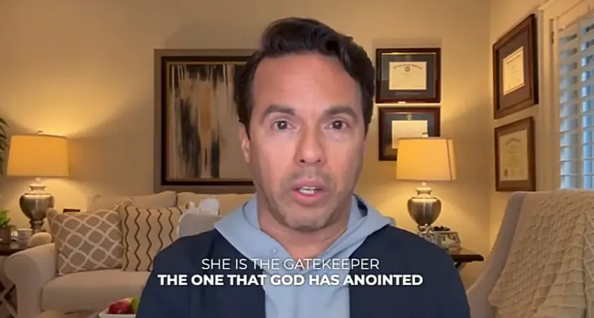 Samuel Rodriguez speaks into a camera in what appears to be a living room setting. In this image from a video, captioned text reads "She is the gatekeeper, the one that God has anointed." 