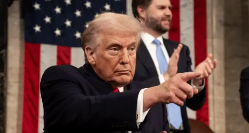 Image of Trump at State of the Union pointing toward audience, with VP JD Vance visible standing behind him and applauding