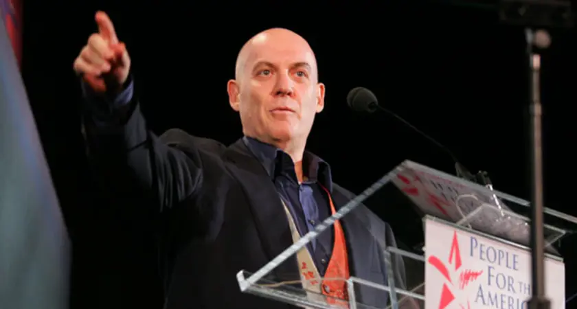 Howie Klein standing behind a podium 