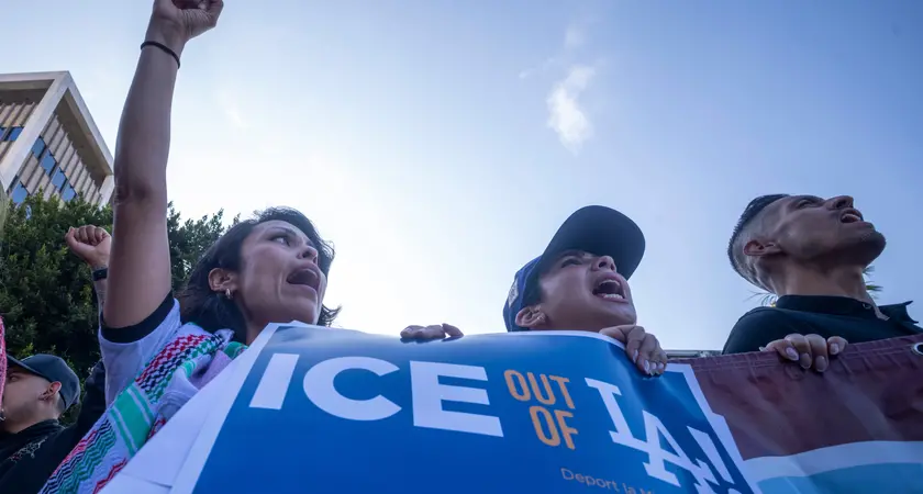People in Los Angeles hold a sign that says "Ice out of LA"