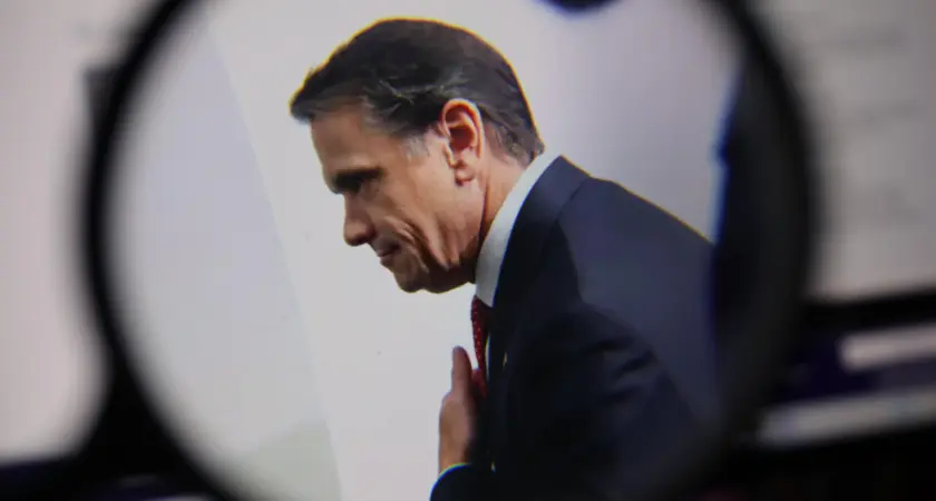 A photo of Todd Blanche with a graphic of a magnifying glass around the photo. 
