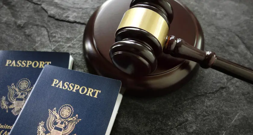 A gavel sits next to two American passports