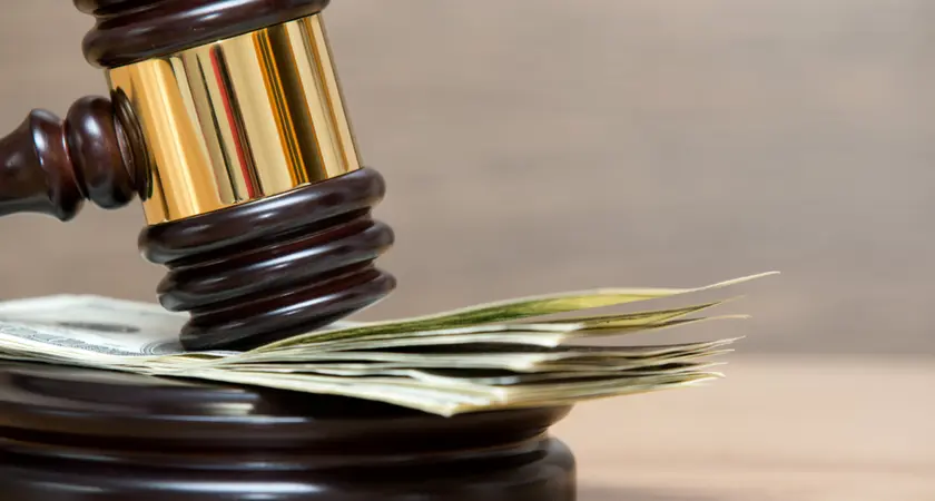 A gavel resting on a stack of money