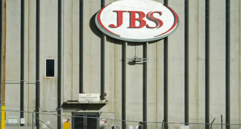 A sign on a wall that says "JBS"