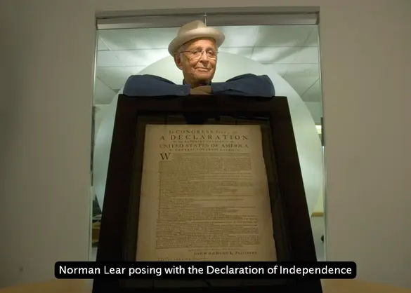 People For founder Norman Lear posing with a copy of the Declaration of Independence