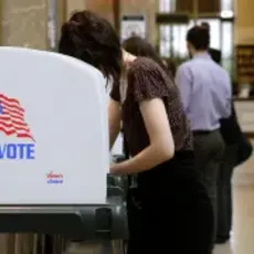 a person is voting at a polling booth