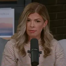 Allie Beth Stuckey, white woman with hair below her shoulders, speaks while seated behind a microphone in what appears to be a home office setting.