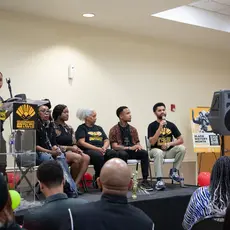 Speakers gather on stage to discuss the importance of teaching Black history