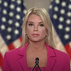 Image of Pam Bondi speaking at RNC, standing at microphone in bright pink suit with American flags visible behind her. 