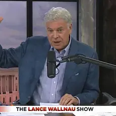 Lance Wallnau in his studio with image of US Capitol projected behind him