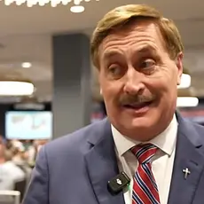 Mike Lindell, in suit and tie, is speaking to a reporter from his Aug. 11, 2026 election watch party.