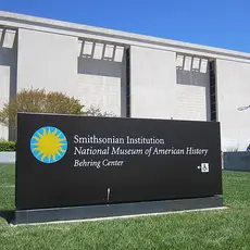 Photo shows exterior of museum with sign out front that says Smithsonian Institution National Museum of American History Behring Center