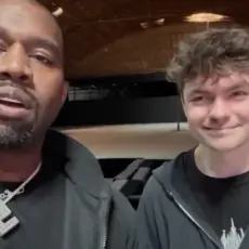 Nick Fuentes With Kanye West, who is wearing a large swastika necklace