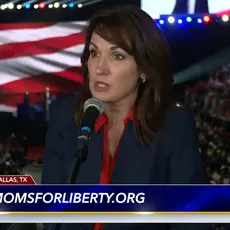 Tina Descovich is seated with a crowd shot of the RNC midterm convention behind her. Beneath her image is chyron with the logo for FlashPoint and text momsforliberty.org.