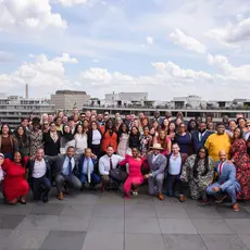 A group of Young Elected Officials posing on the roof of a building.