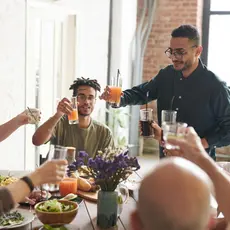 A group of people toast around a thanksgiving dinner