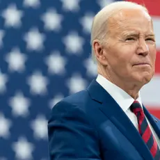 President Biden in front of an American flag.