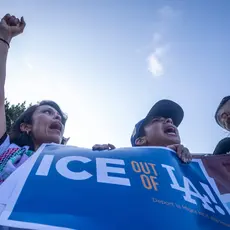 People in Los Angeles hold a sign that says "Ice out of LA"