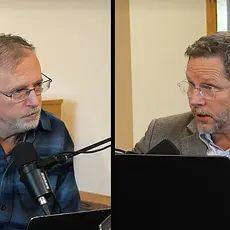 Split screen shows Kevin Swanson on the left, Raymond Simmons on the right, both seated in what appear to be modern church buildings. Swanson is speaking into a microphone and Simmonds has a laptop open in front of him. 