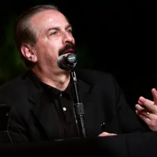 Joseph Farah speaks at a microphone