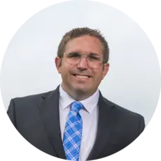 A photo of Rio Tazewell in a gray suit and blue tie.