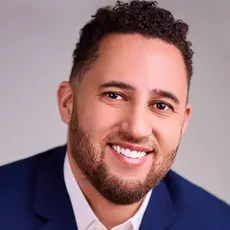 Headshot of Svante Myrick wearing dark blue suit.