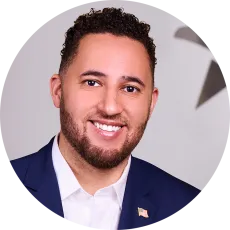 A headshot of Svante Myrick wearing a blue suit.