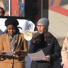 A woman speaks into a megaphone