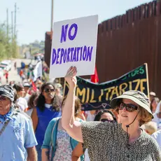 Activists walk along the U.S.-Mexico border to protest deportation.