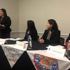 A group of four women speak at a panel