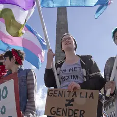 Crowd in Asheville, North Carolina holds signs, waves symbolic flags, and protests the North Carolina's HB2 law that restricts rights to those who are gay or transgender