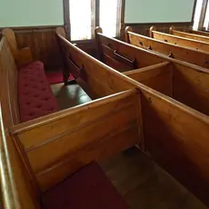 Church pews with dividers in the middle of each row
