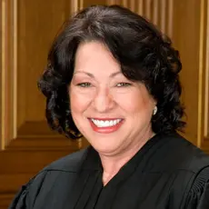 Supreme Court Justice Sonia Sotomayor wearing her black robe and smiling