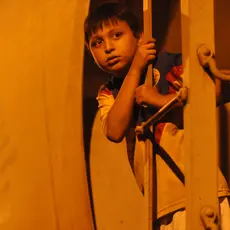 An 11-year-old Honduran riding the freight train they call La Bestia.