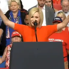 Paula White prays at a Trump rally.