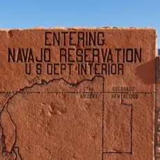 At Grand Canyon National Park, a rock sign displays a map area of the Navajo Nation, one of many Native American tribes that are battling higher rates of the coronavirus.