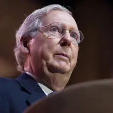 Mitch McConnell stands at a podium.