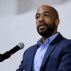 Mandela Barnes standing at a microphone.