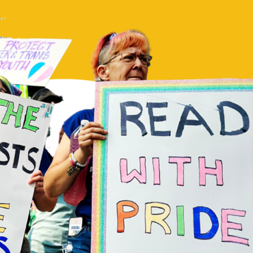 People at a protest hold signs that say "ban the fascists save the books" and "read with pride"